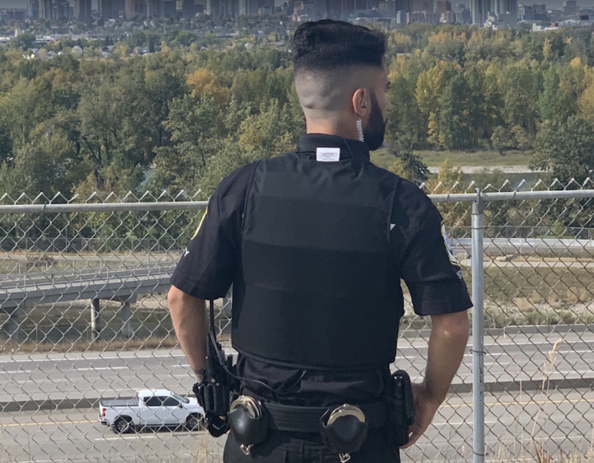 Enforcement Security officer on active patrol overlooking Calgary