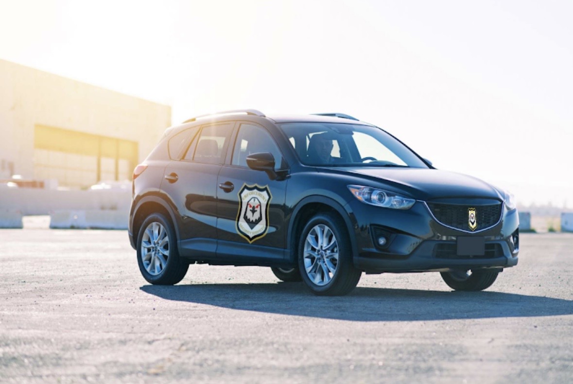 Enforcement Security branded patrol SUV at a commercial site